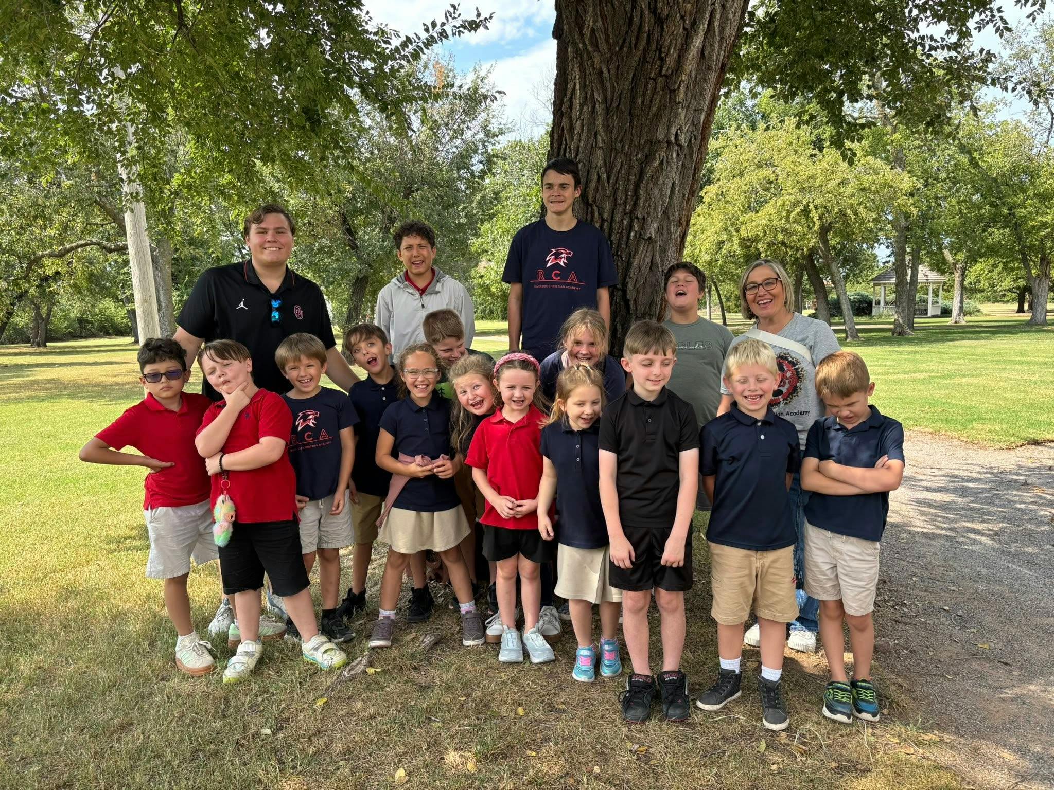 Group of adults and children posing outdoors