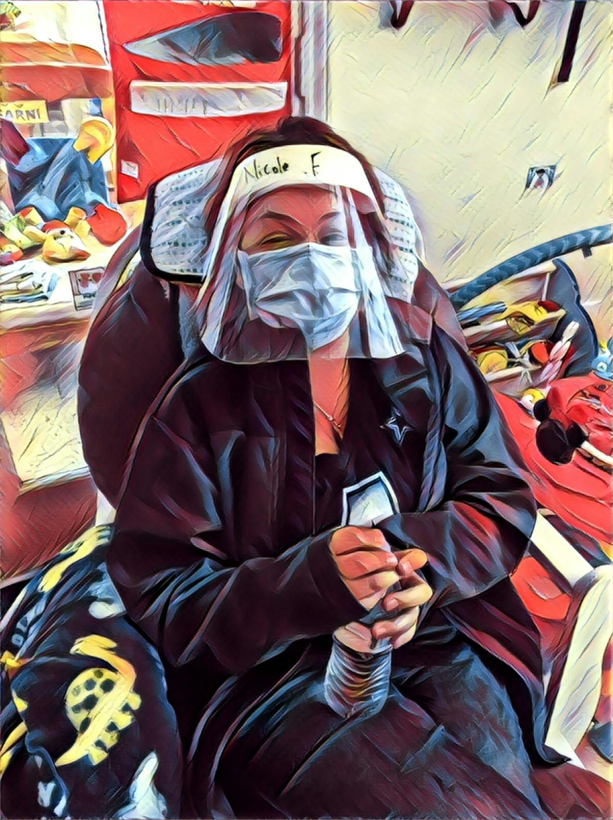 Person wearing a face shield and mask, holding a water bottle