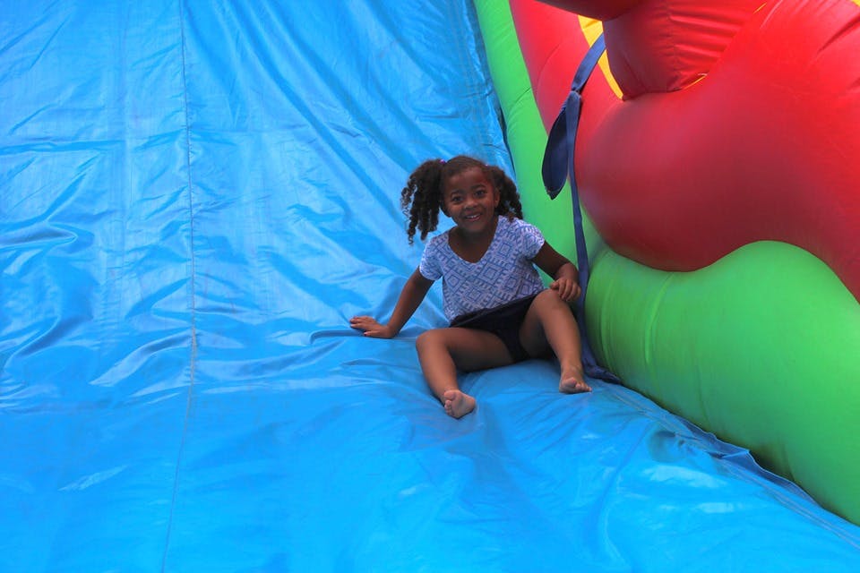 Child sitting on an inflatable slide