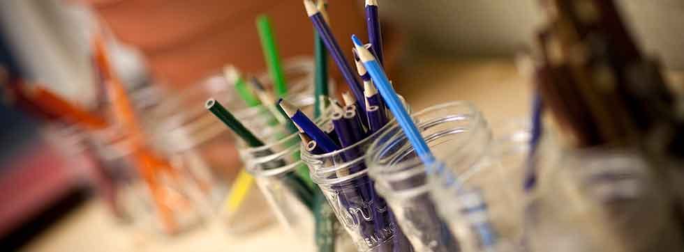 Colored pencils in glass jars