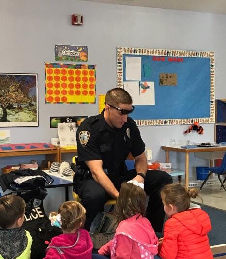 Police officer interacting with children in a classroom