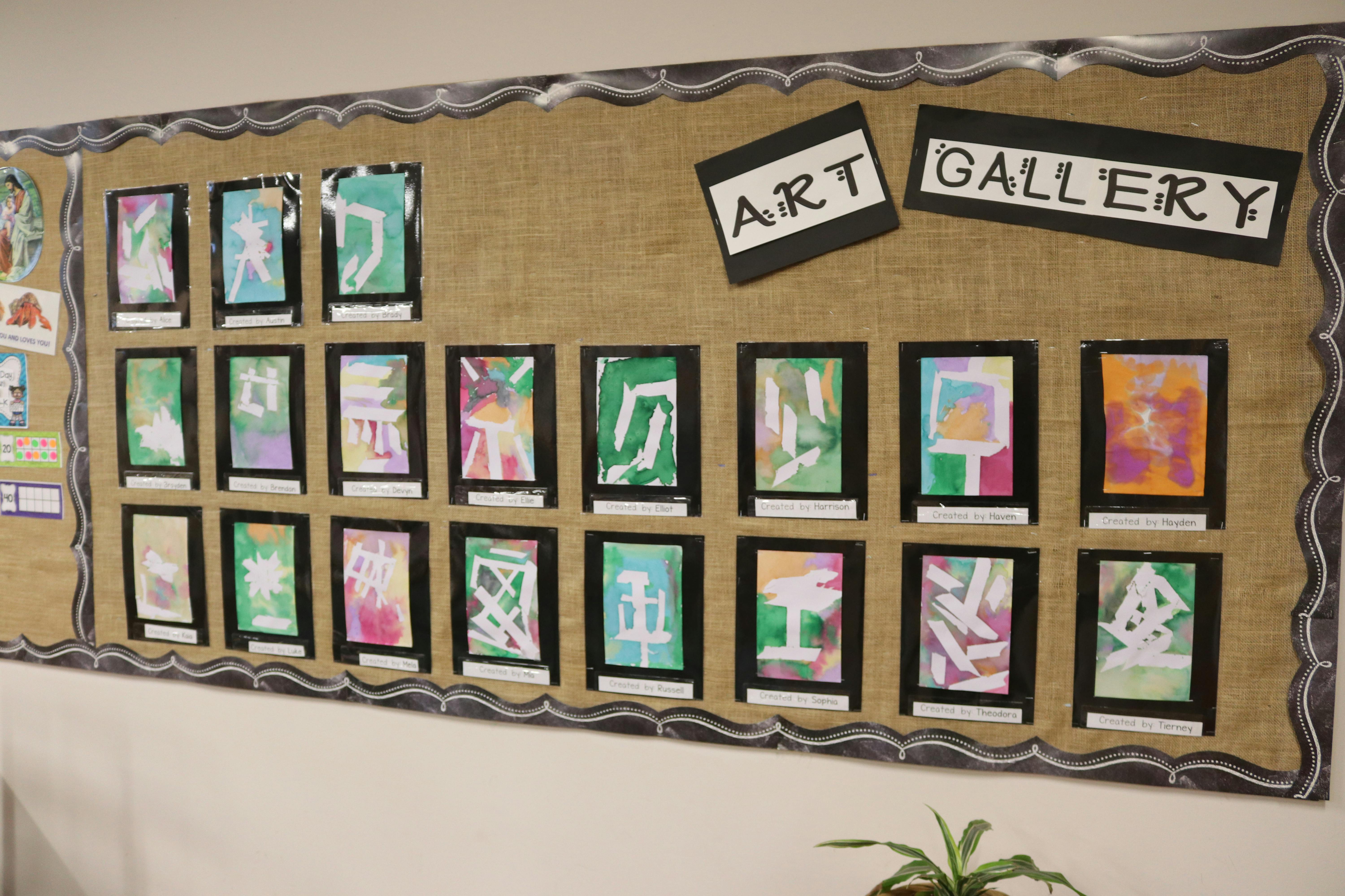 Bulletin board with children's artwork and "ART GALLERY" sign