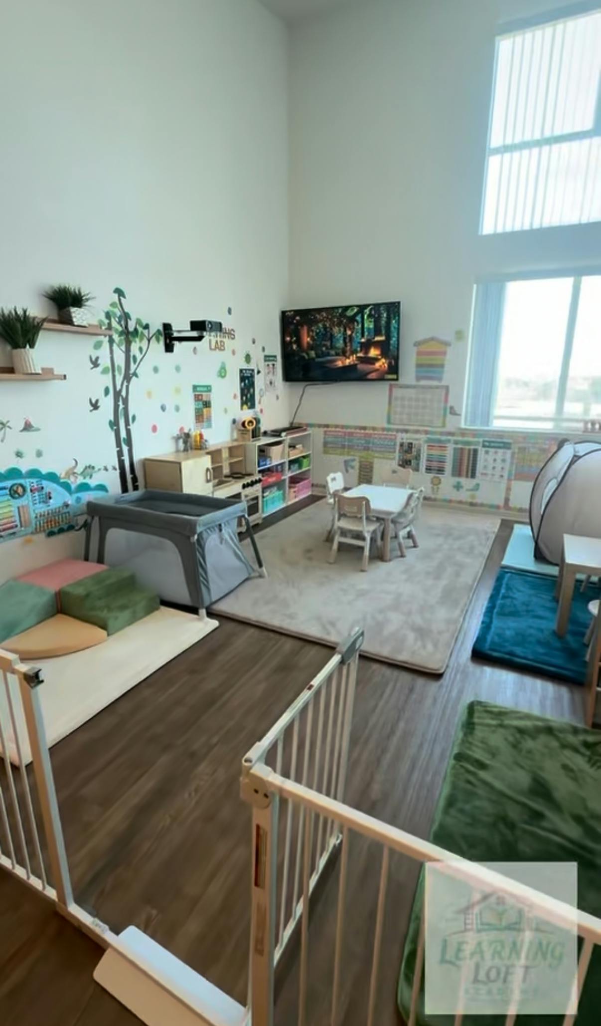 Indoor child learning space with furniture, play equipment, and educational wall art