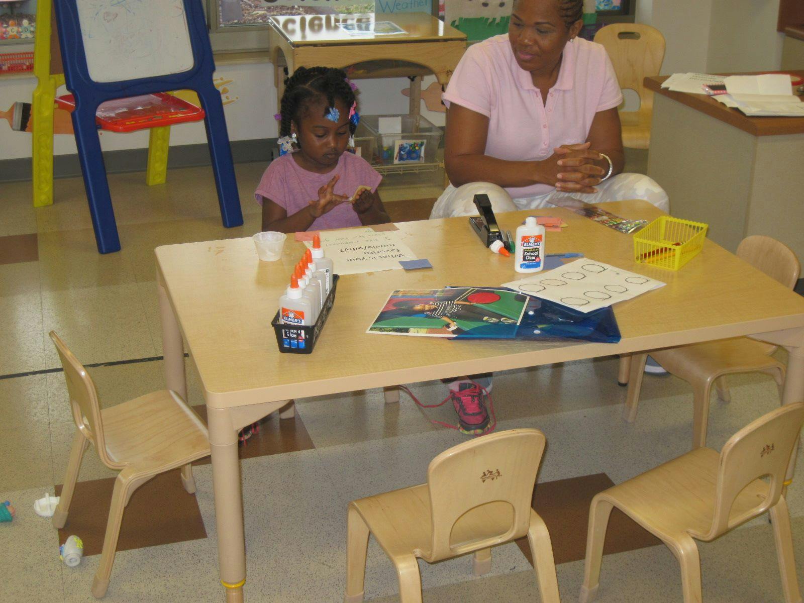 Adult and child at a table with craft supplies