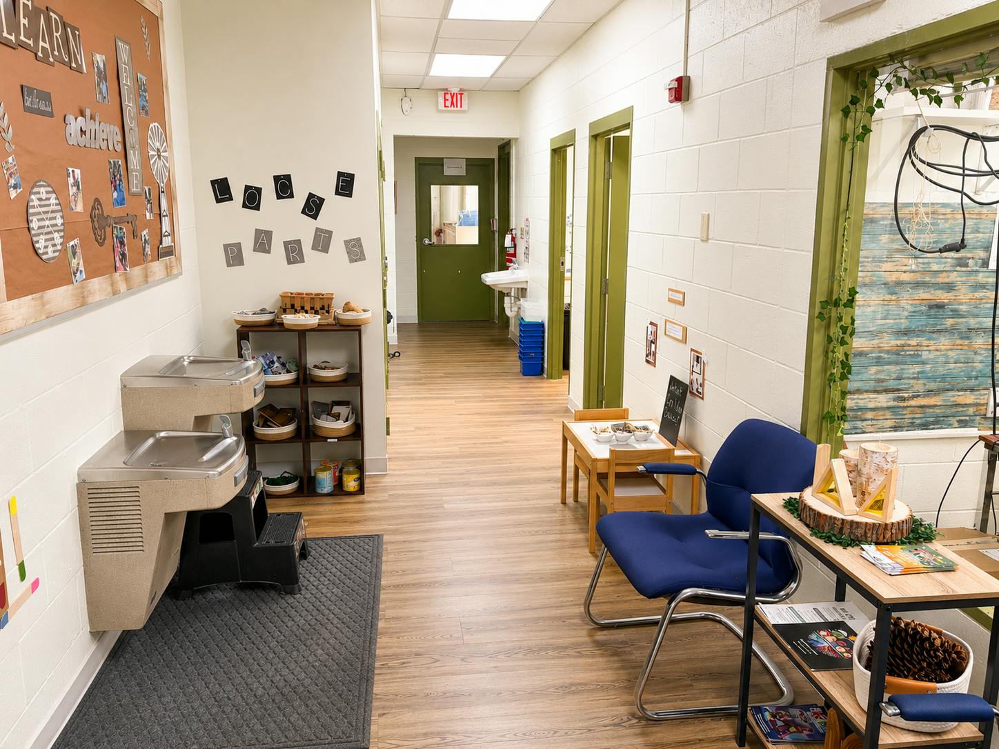 School hallway with a water fountain and loose parts station