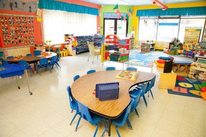 Empty classroom with small tables and chairs