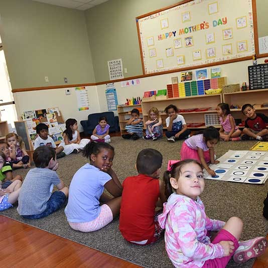Children sitting on the floor in a classroom