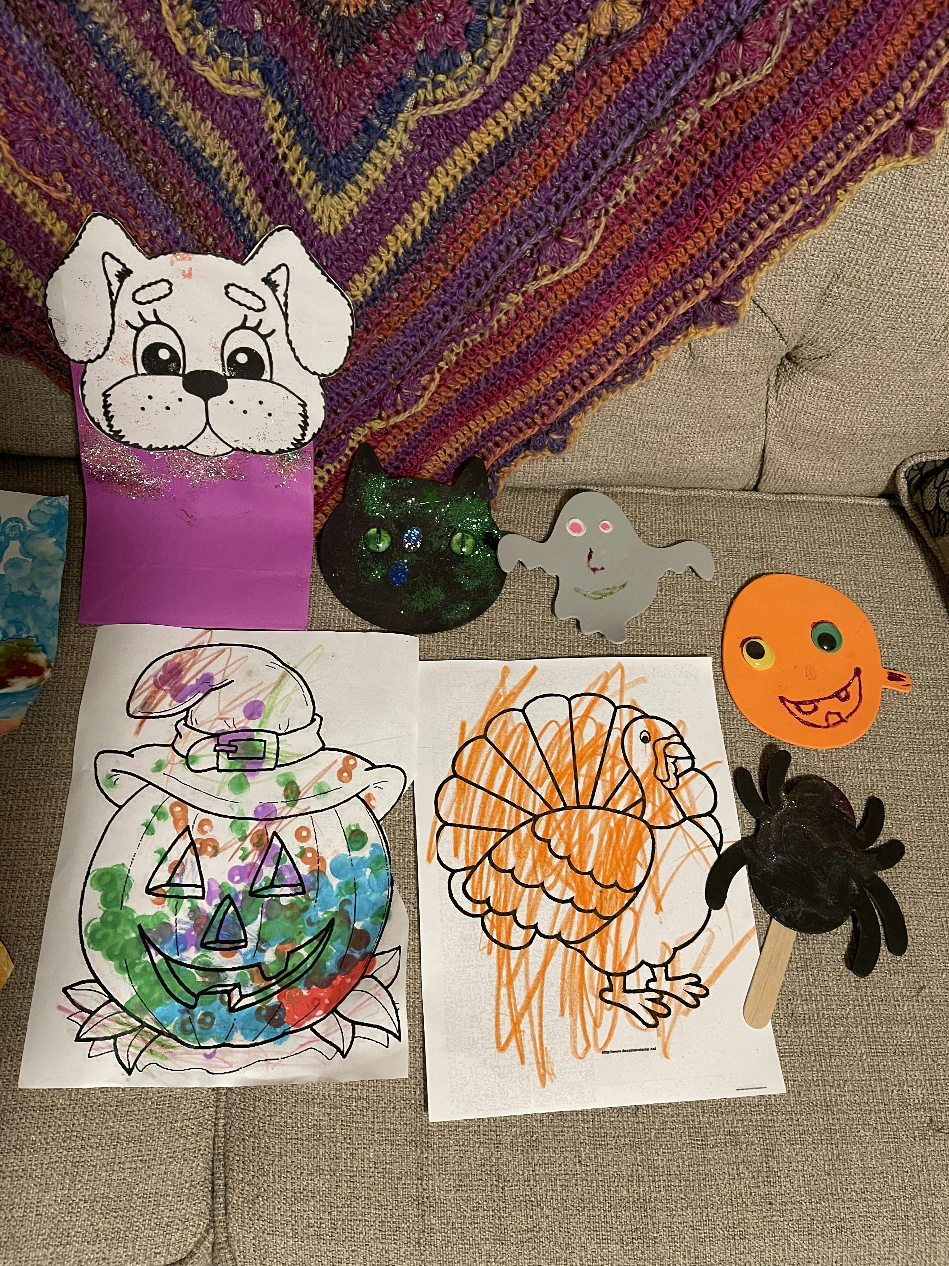 Children's seasonal art projects including a pumpkin, turkey, dog puppet, ghost, and cat