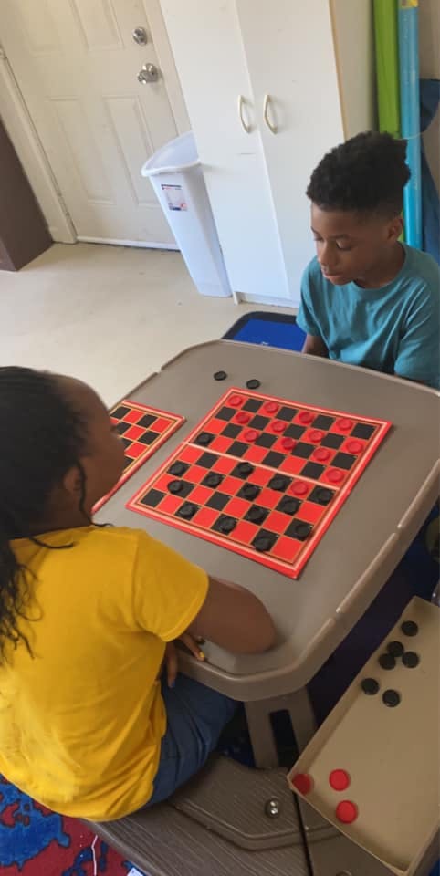 Two children playing checkers