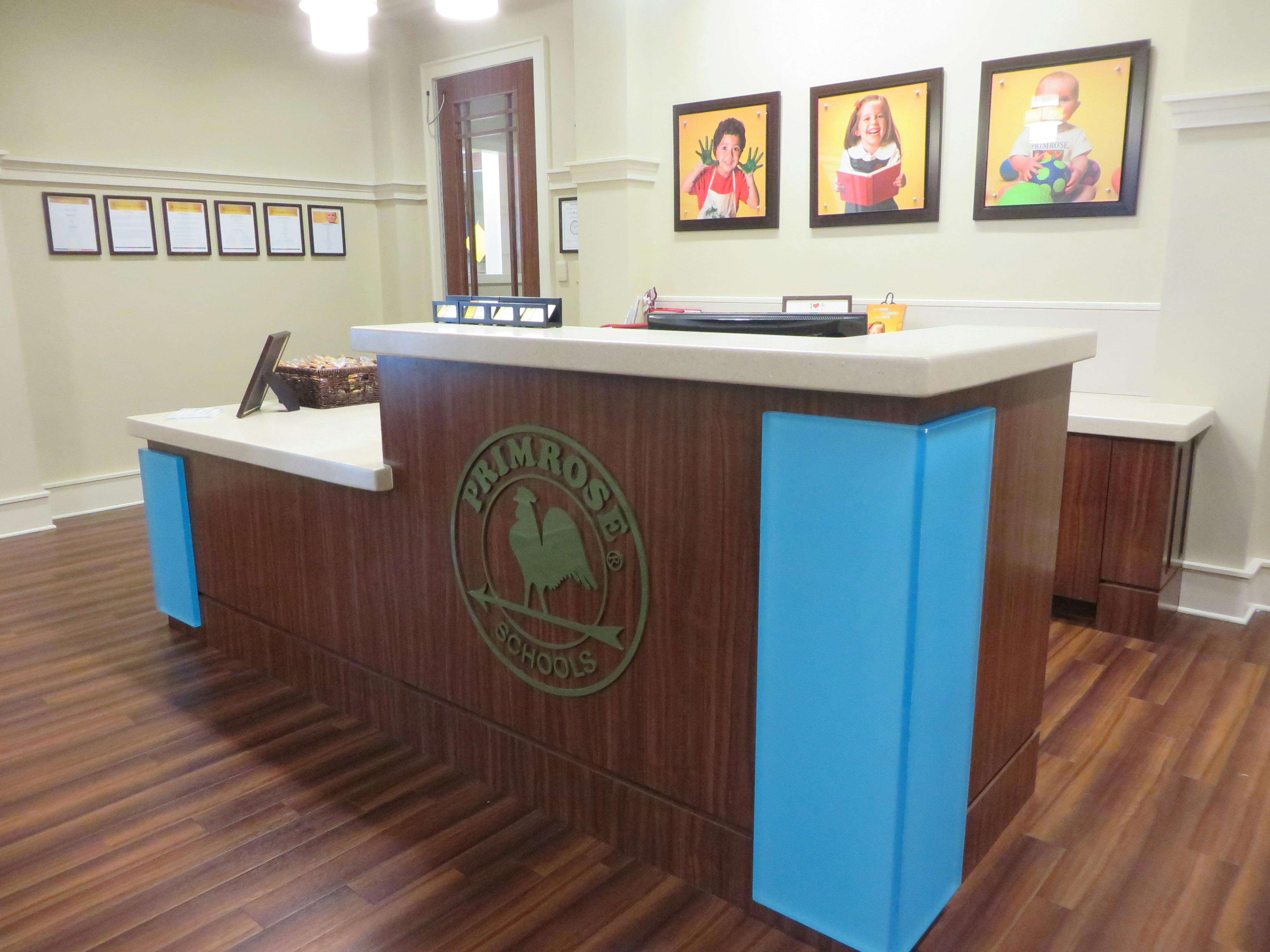 Reception desk with a circular logo and blue panels