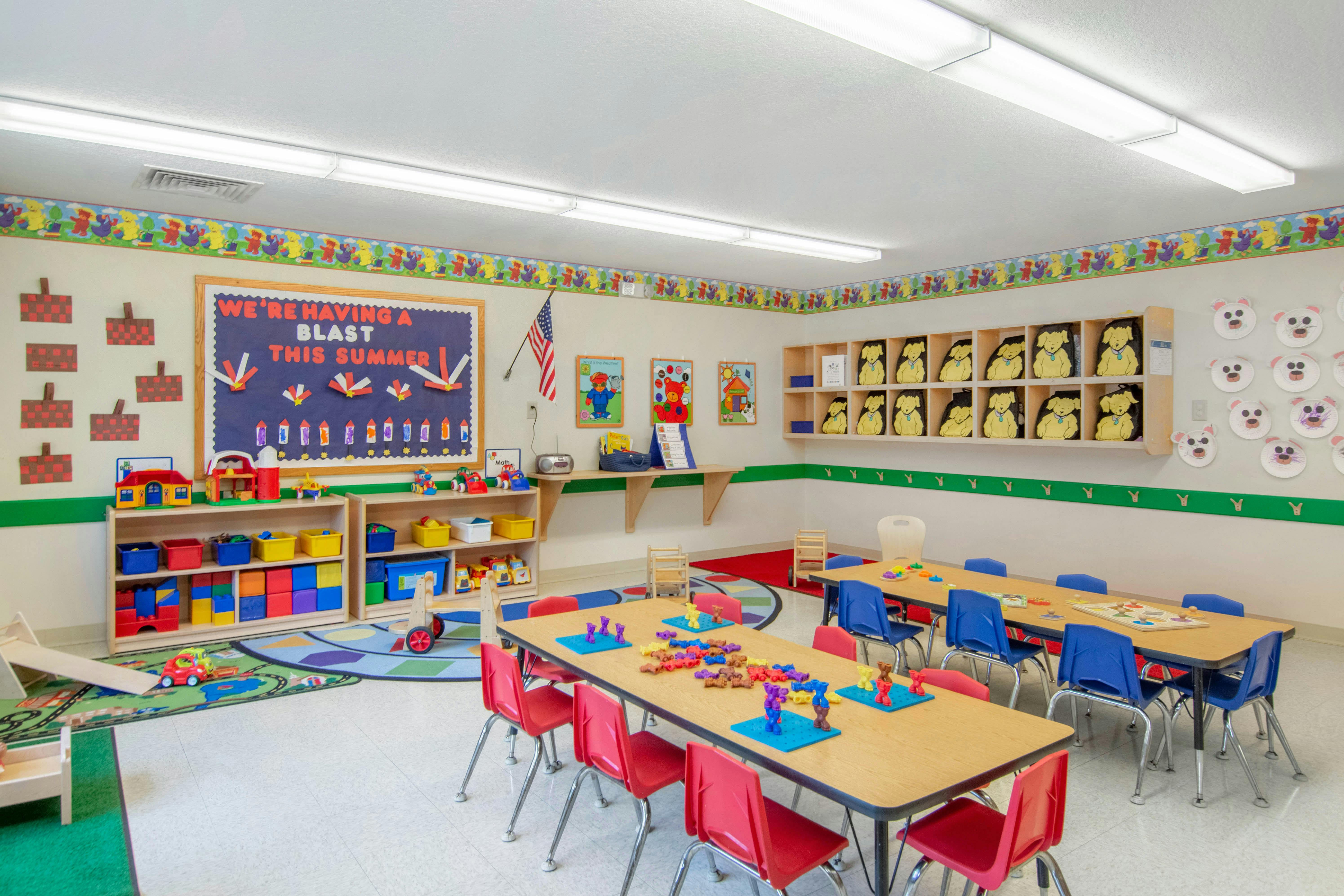 A colorful kindergarten classroom with small tables and chairs