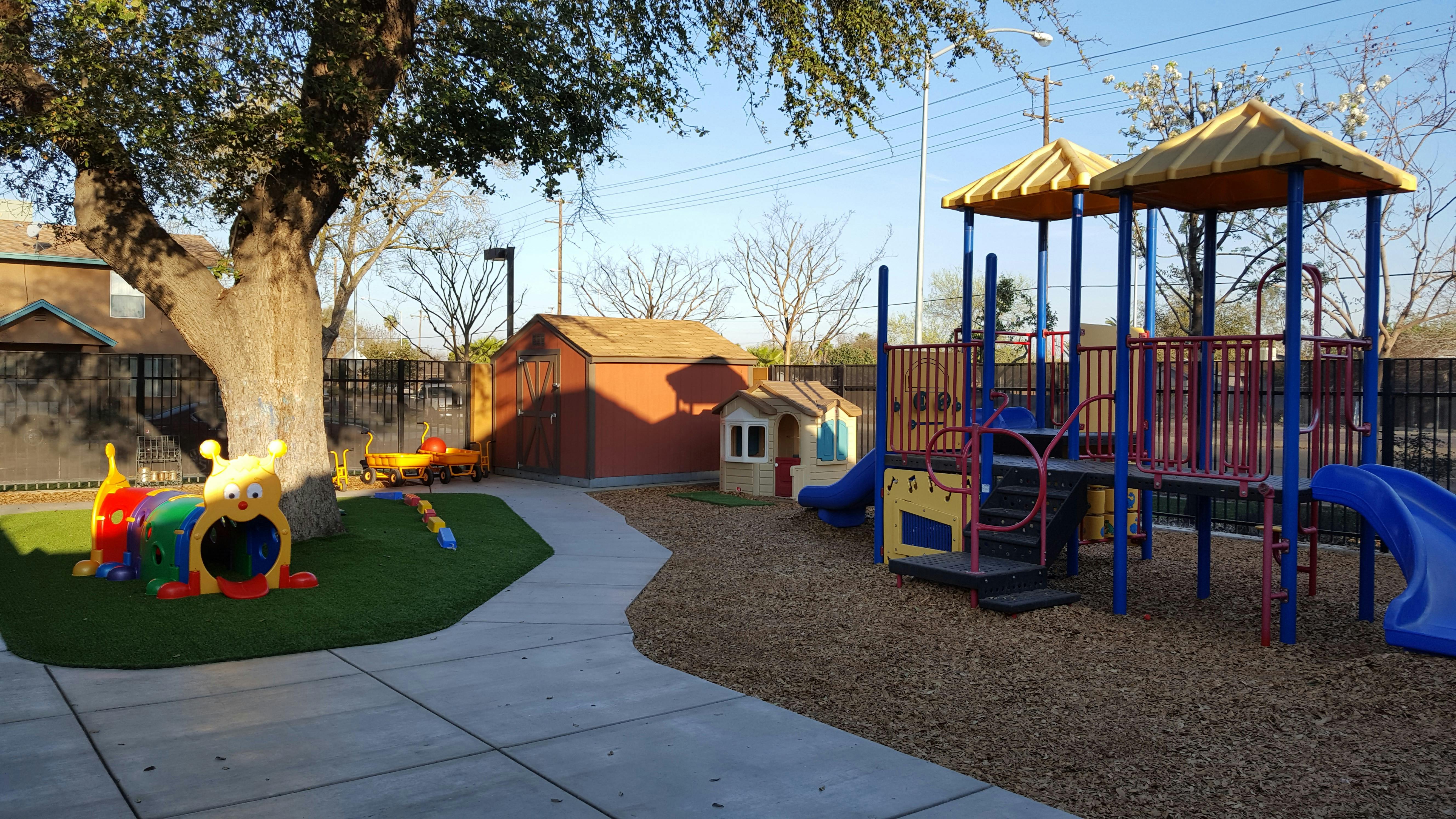 Outdoor playground with slides, climbing structure, and play tunnel