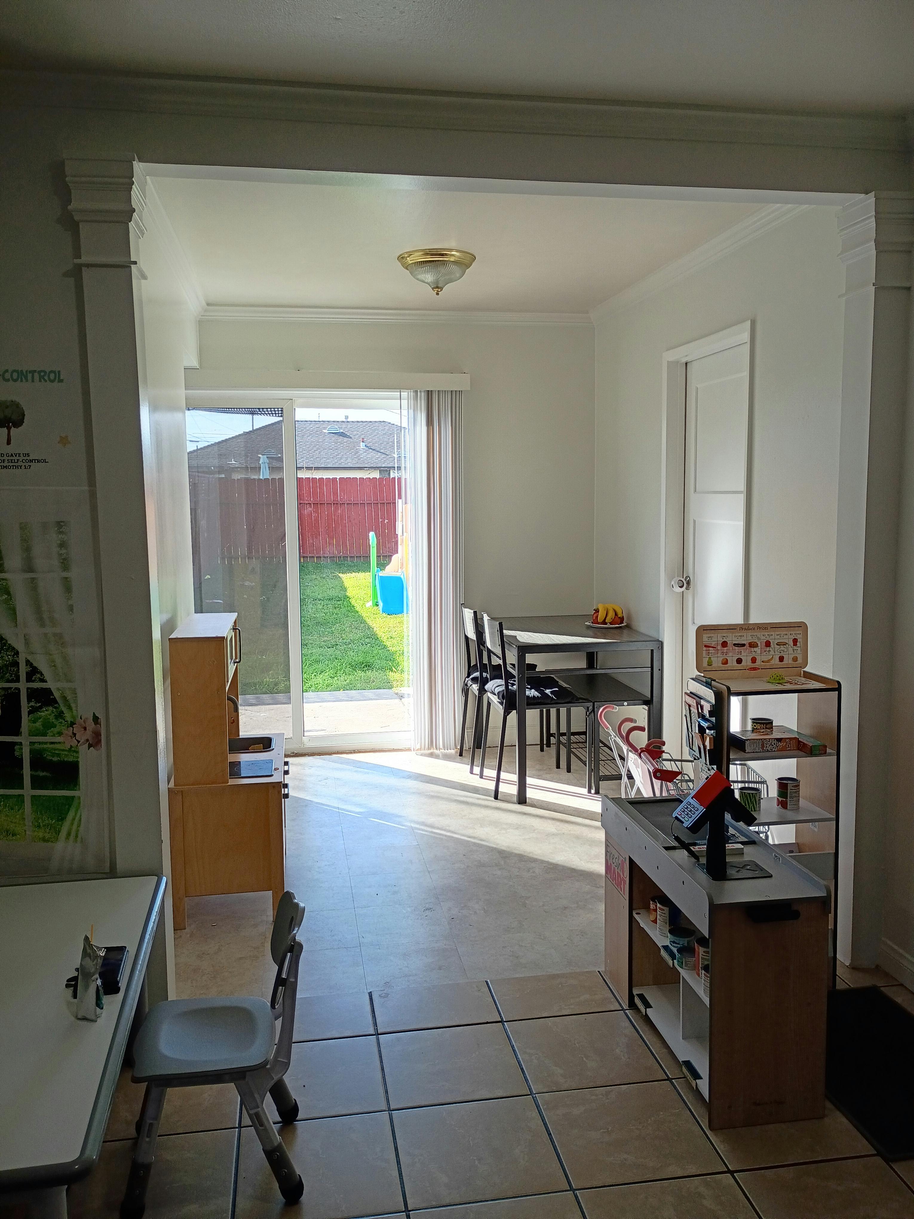 Play kitchen area with a table and chairs, and a large window