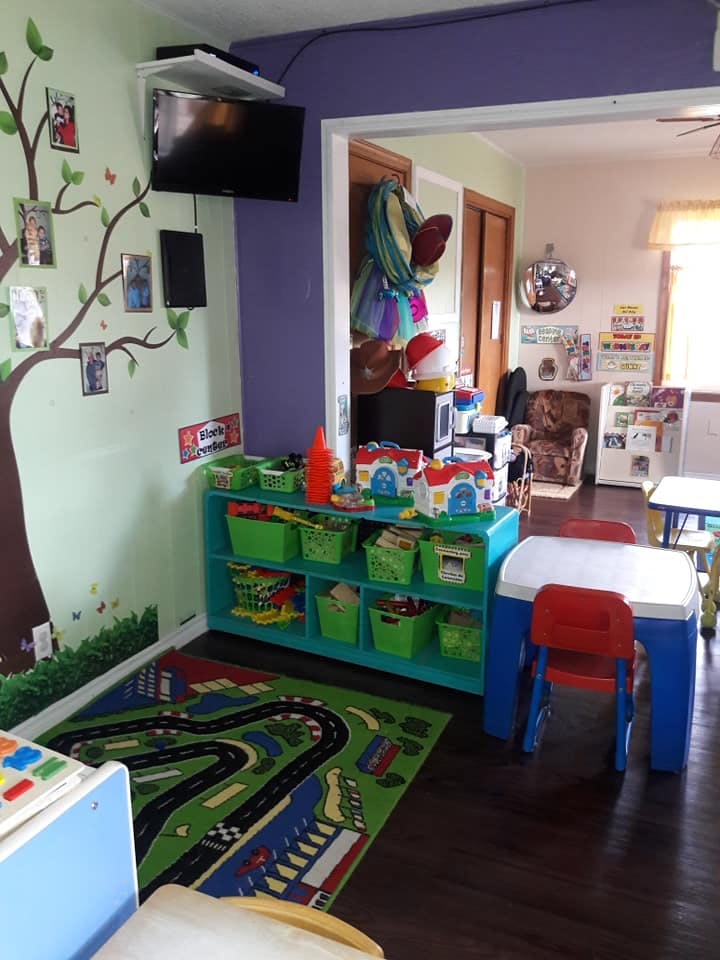 Playroom with toy storage, small table and chairs, and a road-themed rug