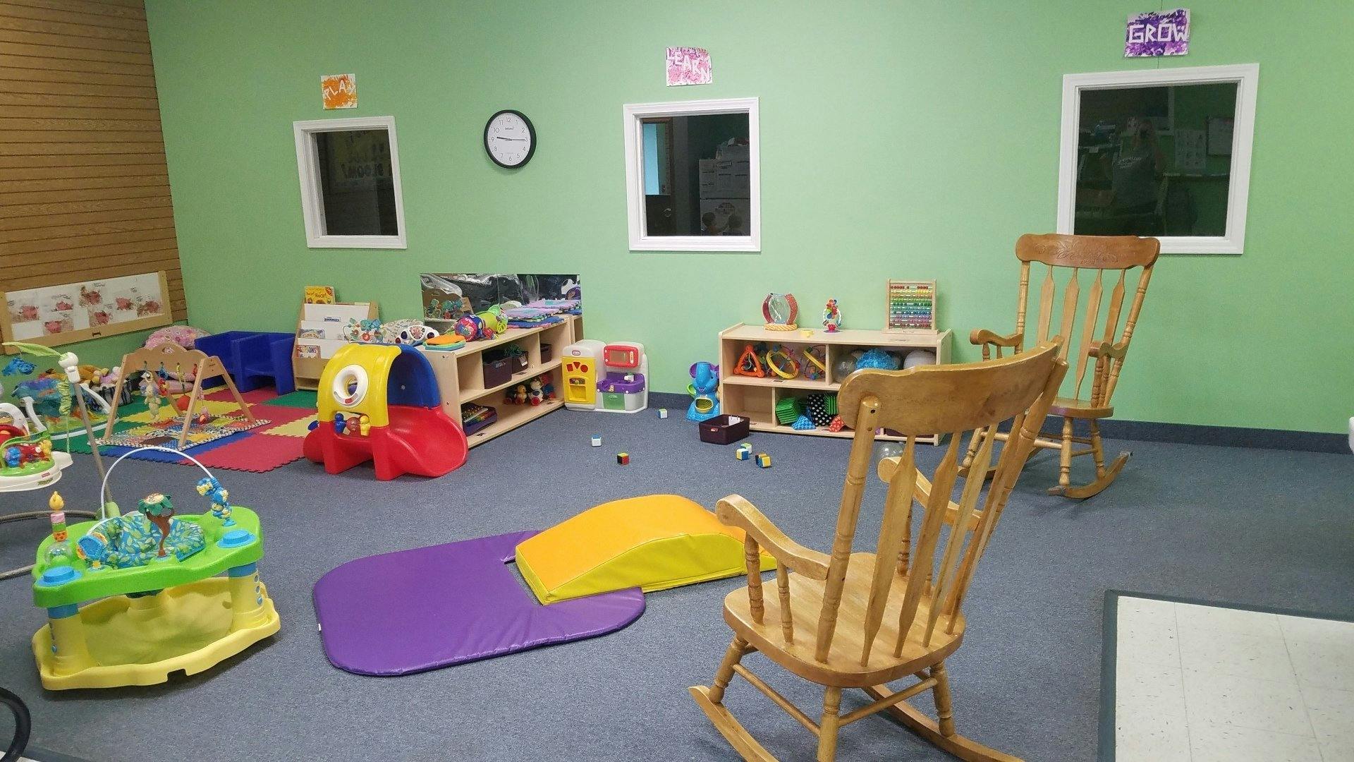 Playroom with various toys, shelves, and two rocking chairs