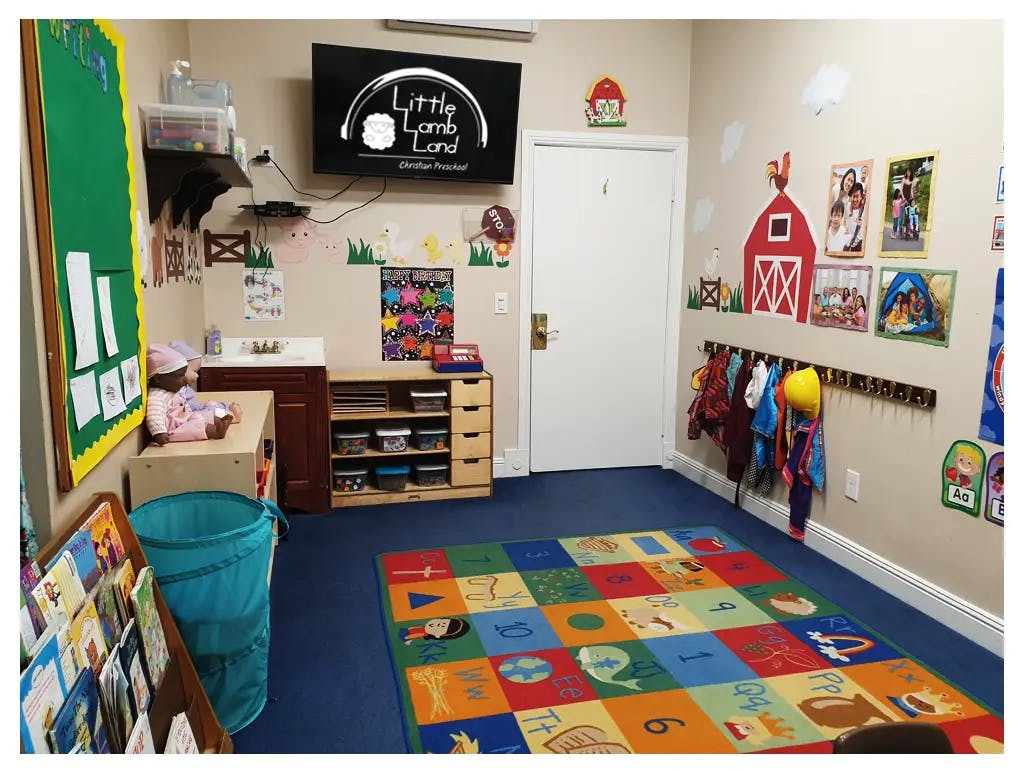 Children's classroom with colorful rug, coat rack, and wall decorations