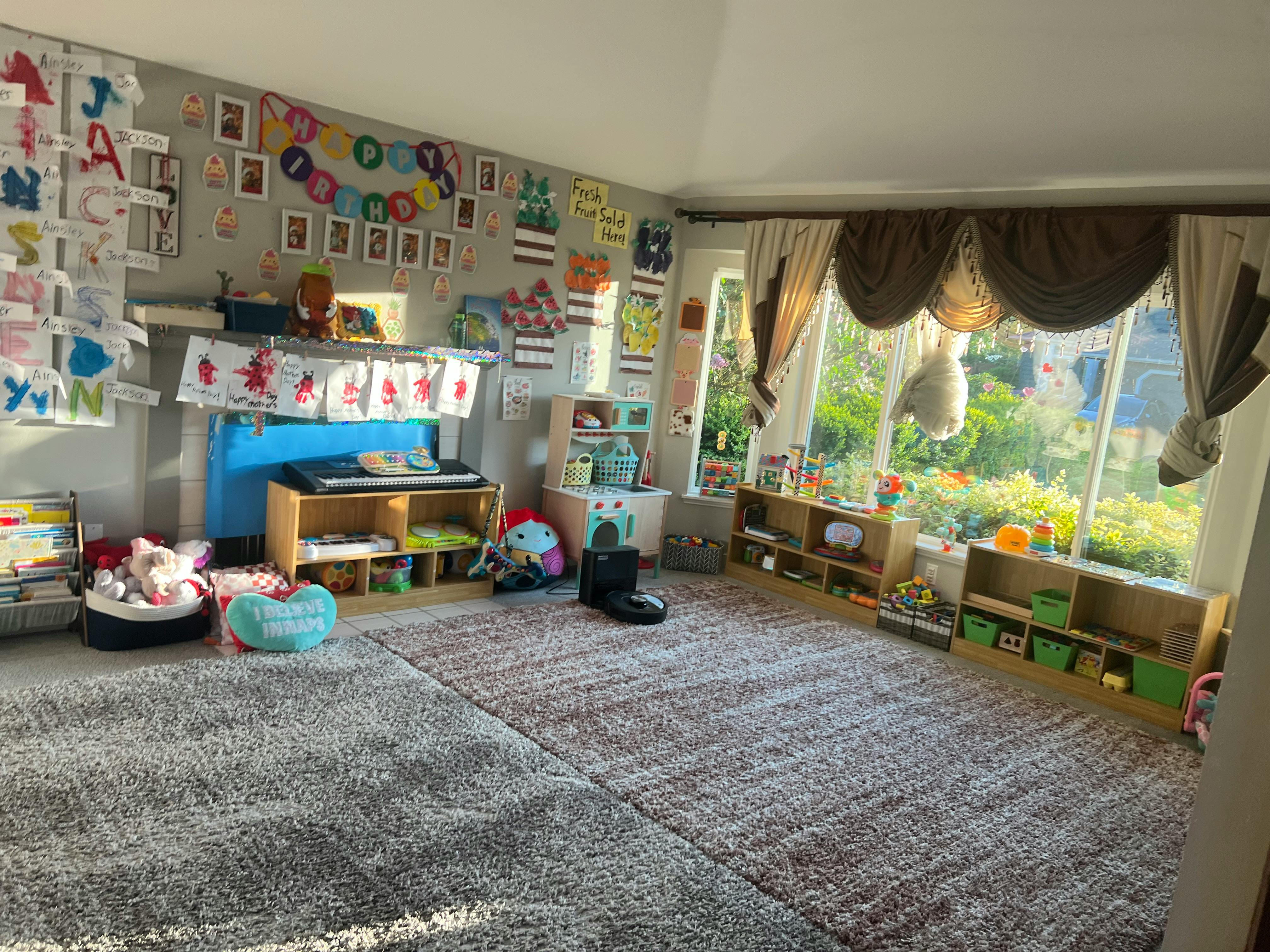 Classroom with children's artwork on walls and large windows