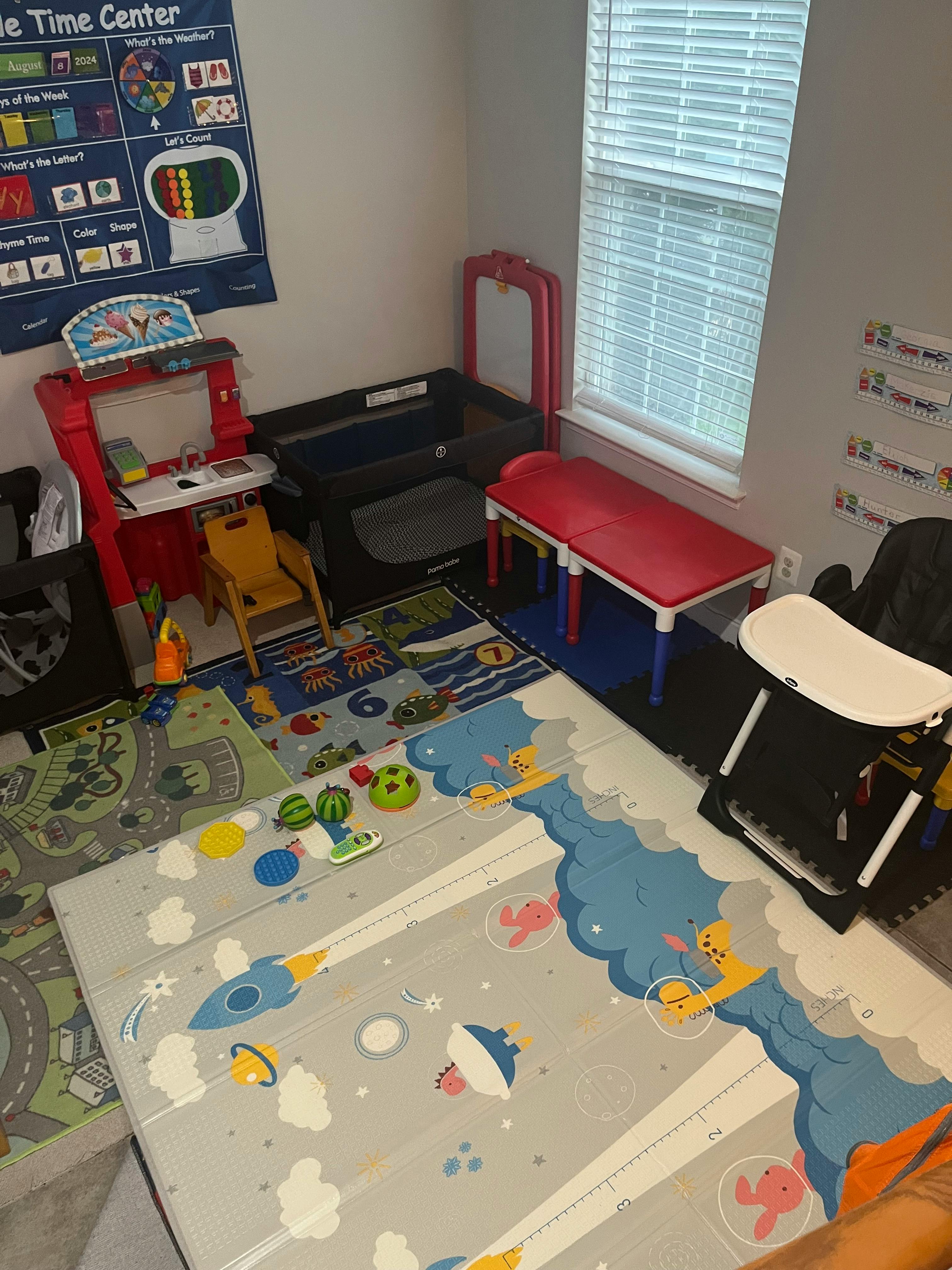 Playroom with various toys, play mats, and child-sized furniture