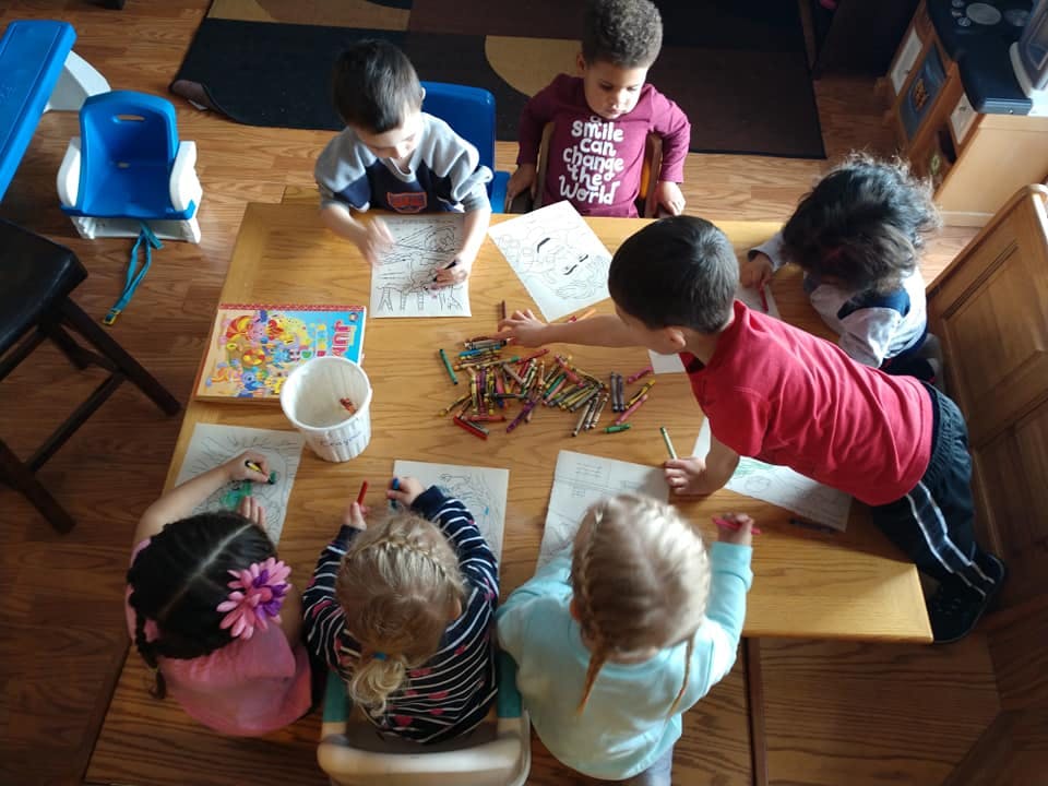 Children drawing and coloring at a table
