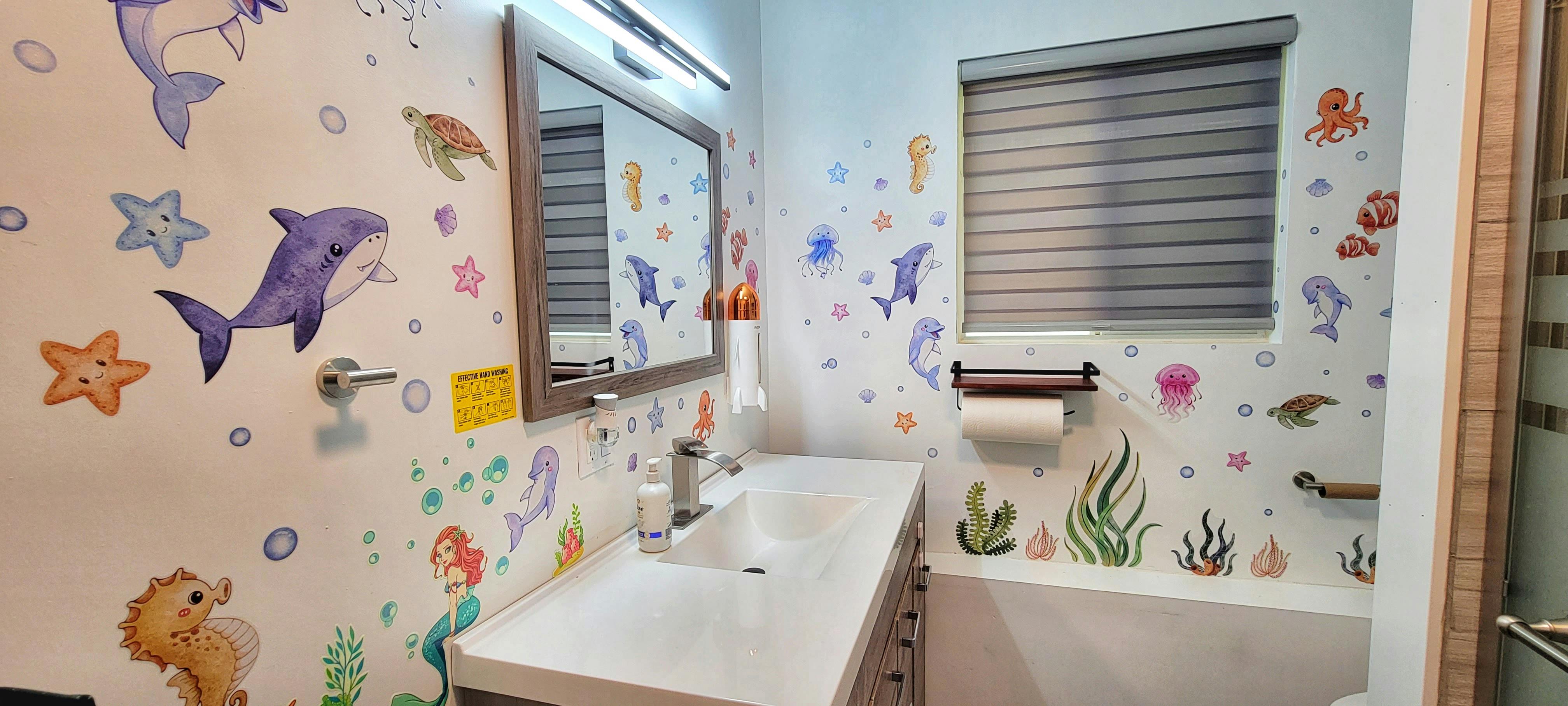 Bathroom with ocean-themed wall decals