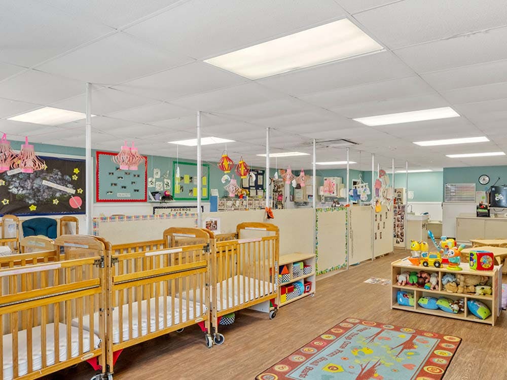 cribs in a daycare room