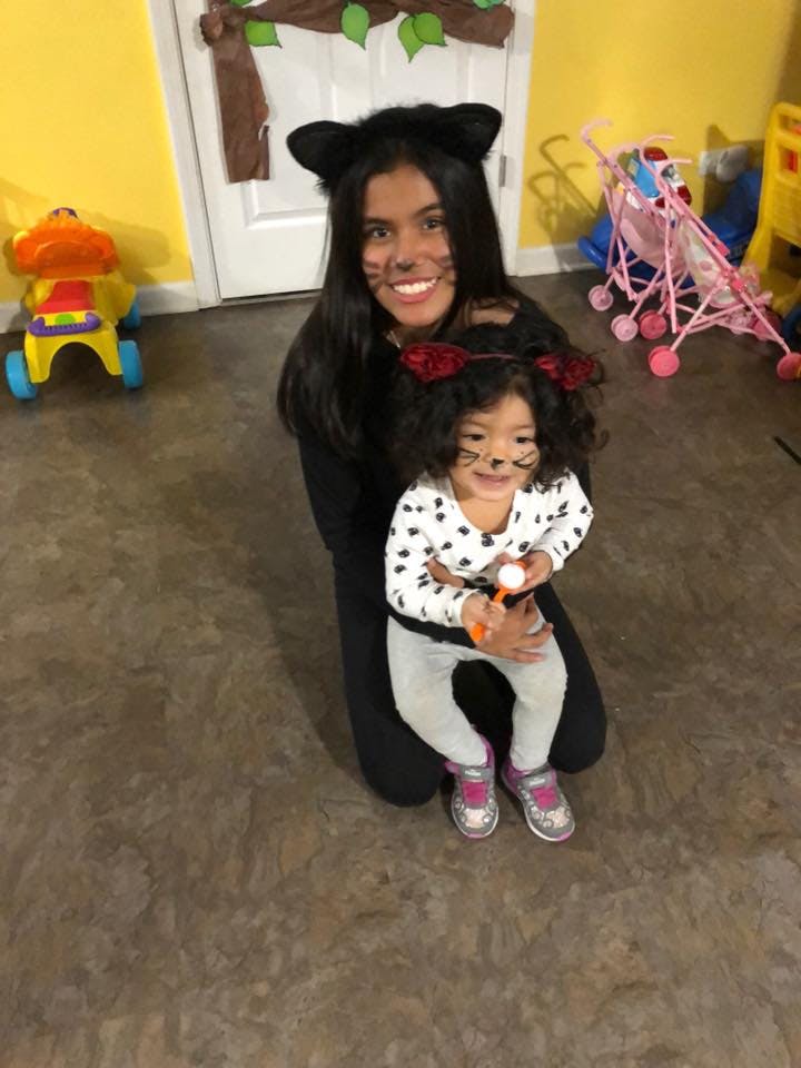 Person and child in cat costumes