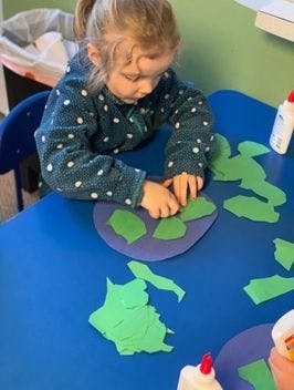 Child doing a craft at a table