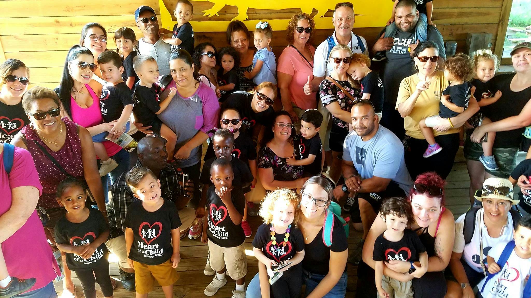 Large group of adults and children posing for a photo