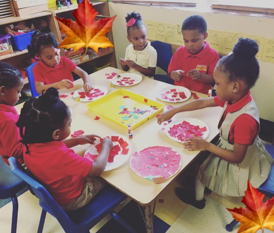 Children doing an art activity at a table