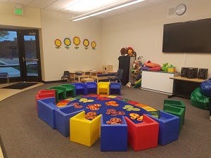 Classroom with colorful chairs and rug