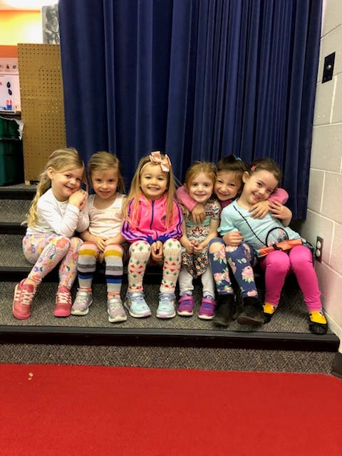 Six children sitting on steps