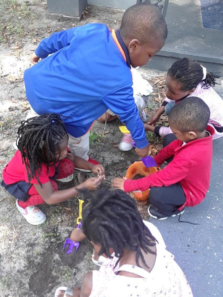 Children playing with toys on the ground