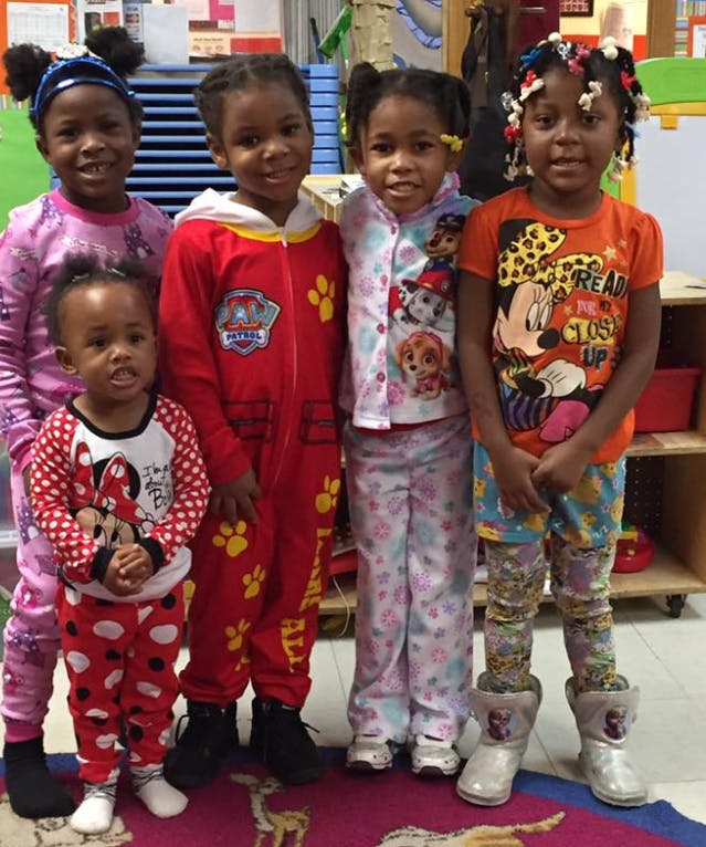 Five children in pajamas standing together