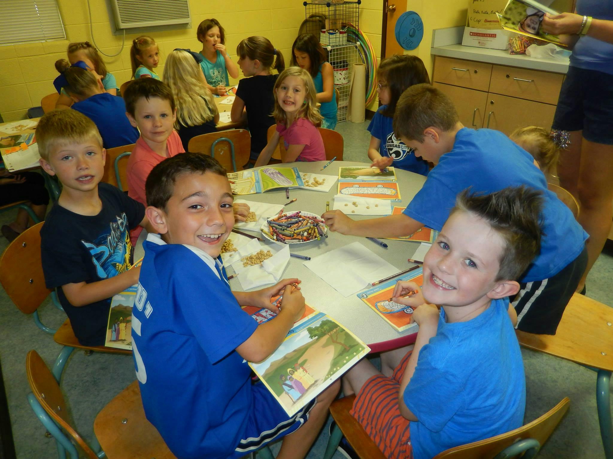 Children sitting at tables in a classroom