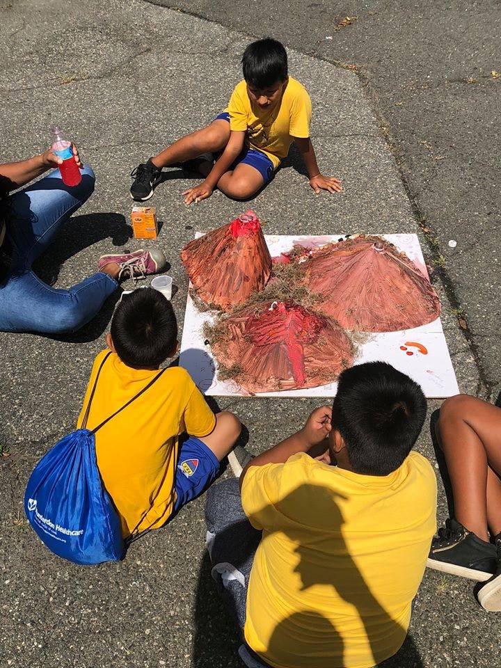 Children sitting around a volcano science project