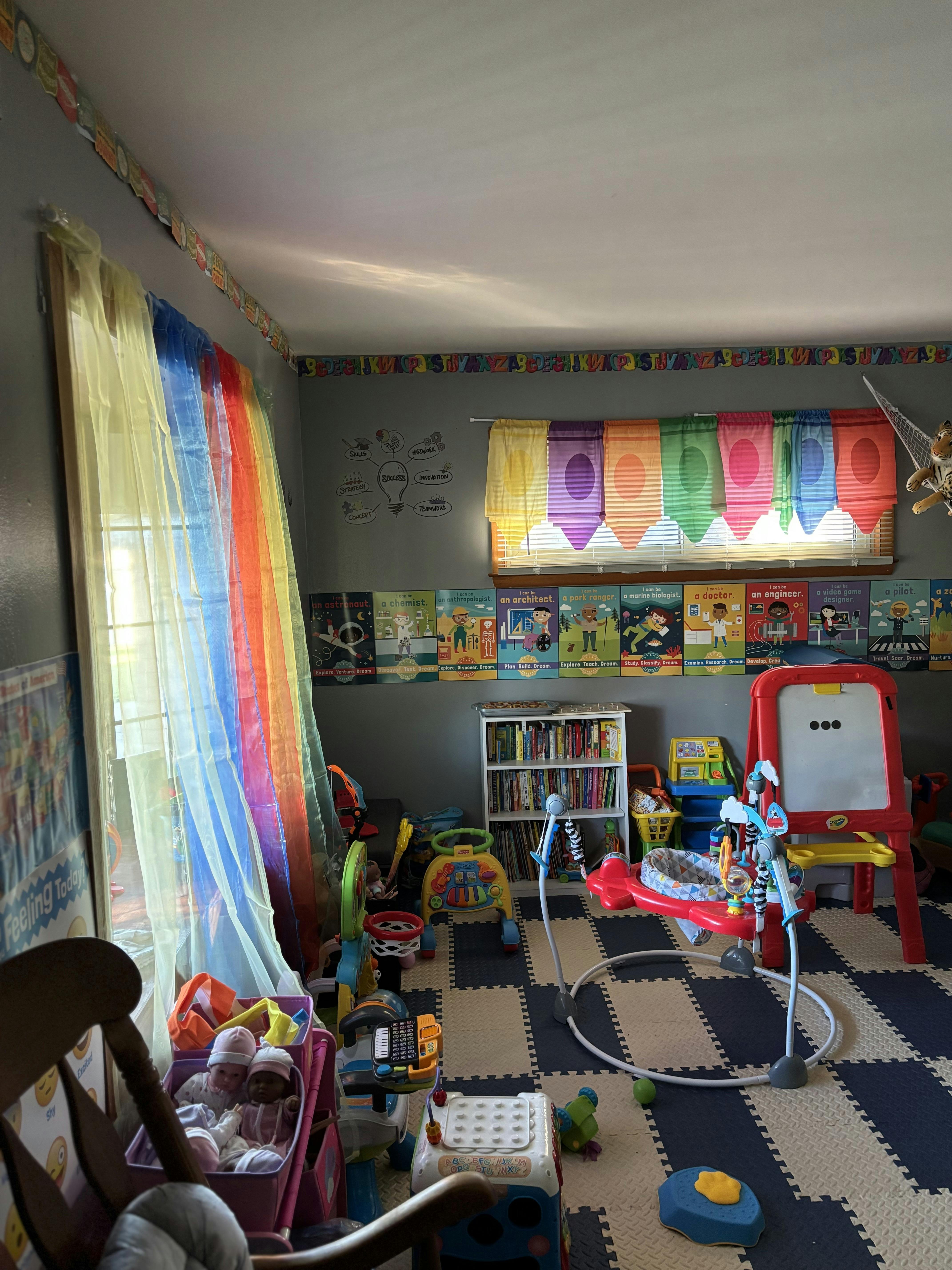 A playroom with colorful curtains, educational posters, and various toys