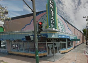 Building with a sign that says "ON STAGE"