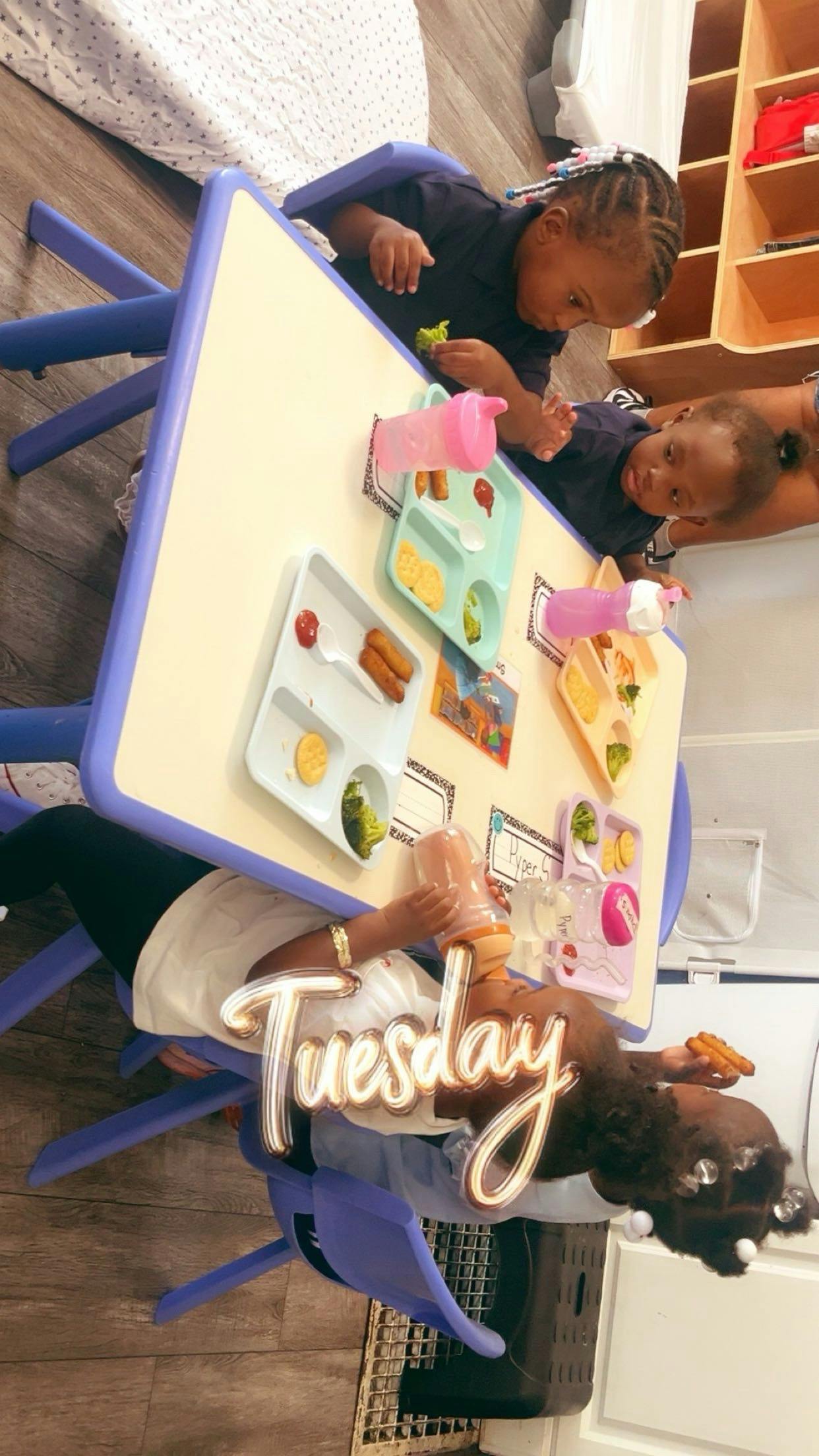 Children sitting at a table eating lunch