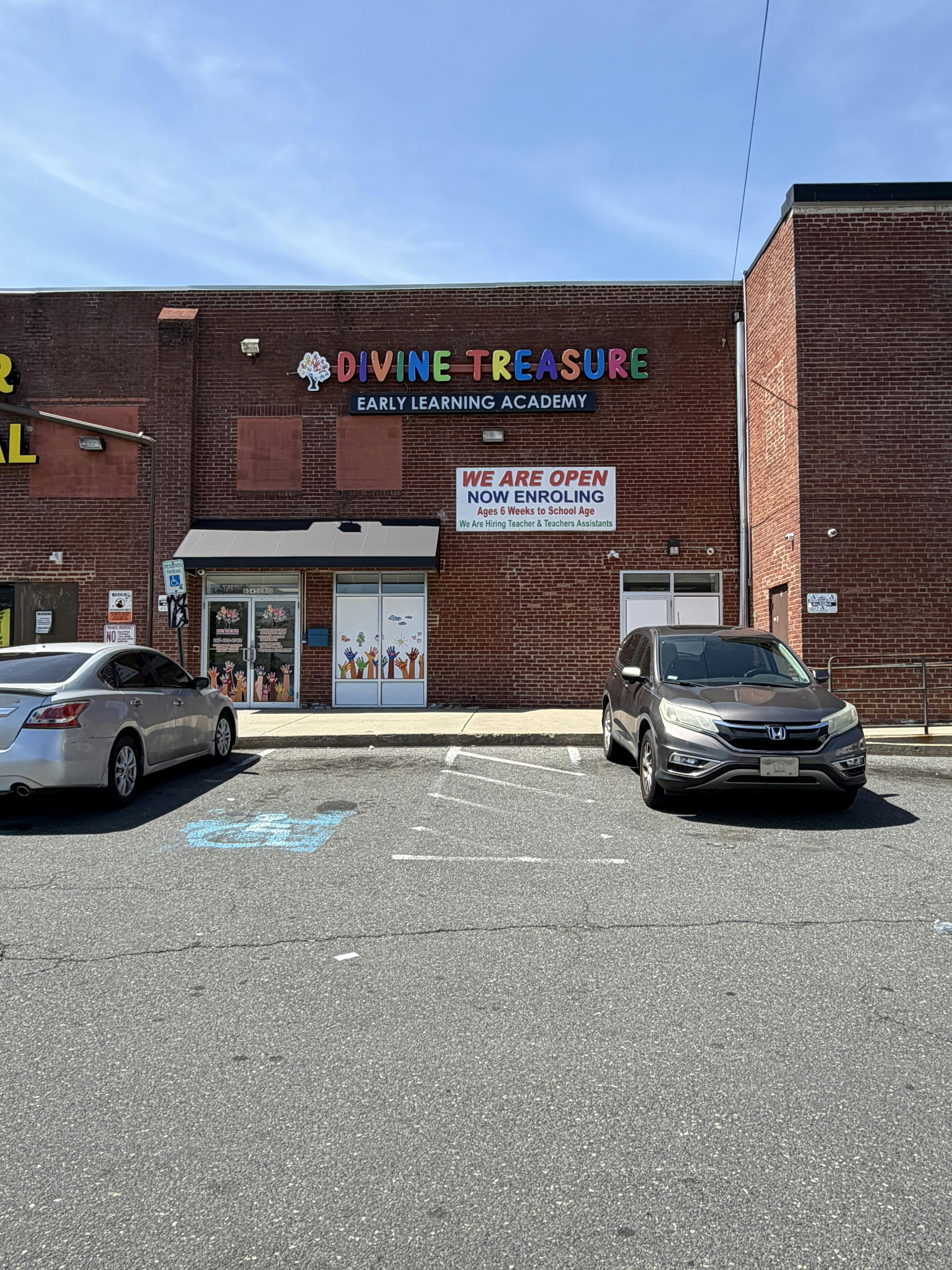 Divine Treasure Early Learning Academy building with two cars in the parking lot