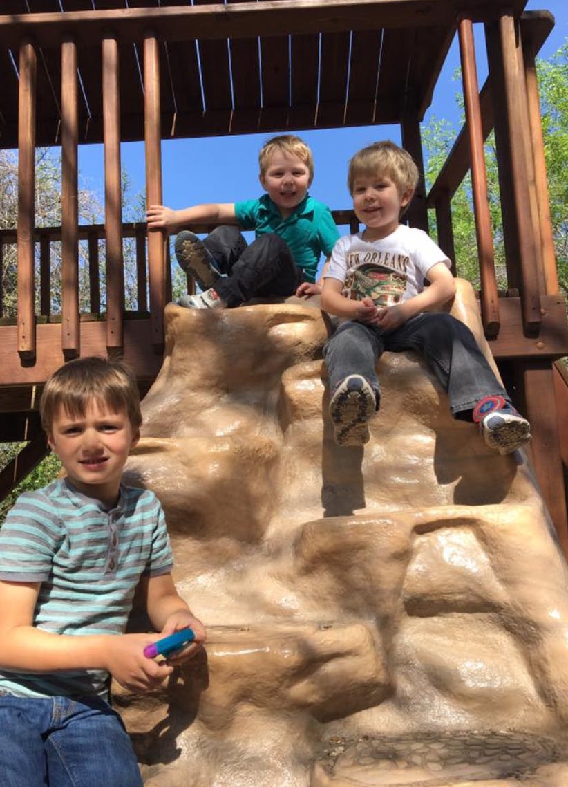 Three children on a playground structure
