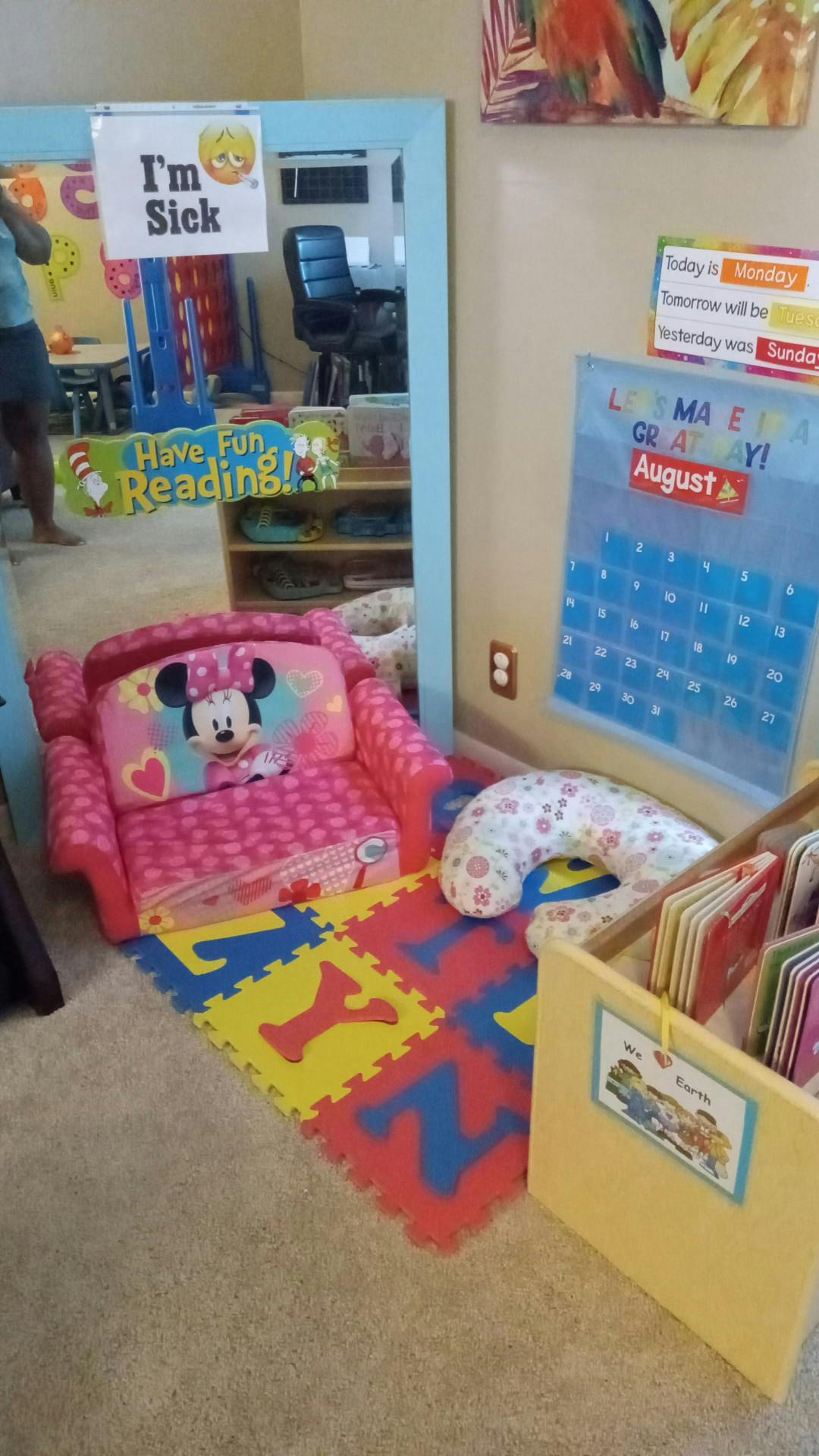 Child's pink armchair with Minnie Mouse design on alphabet mat