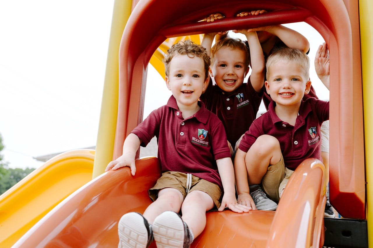 Three children on a playground slide