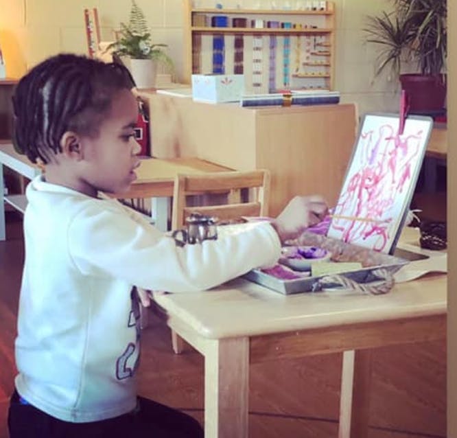 Child painting at a table