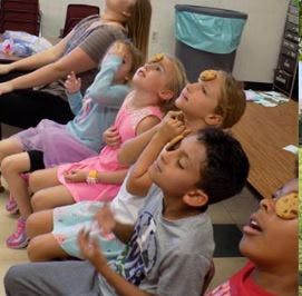 Children and adults balancing cookies on their foreheads
