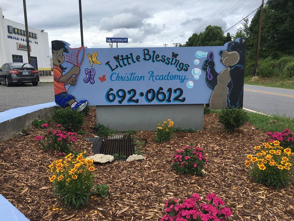 Sign for Little Blessings Christian Academy with a phone number