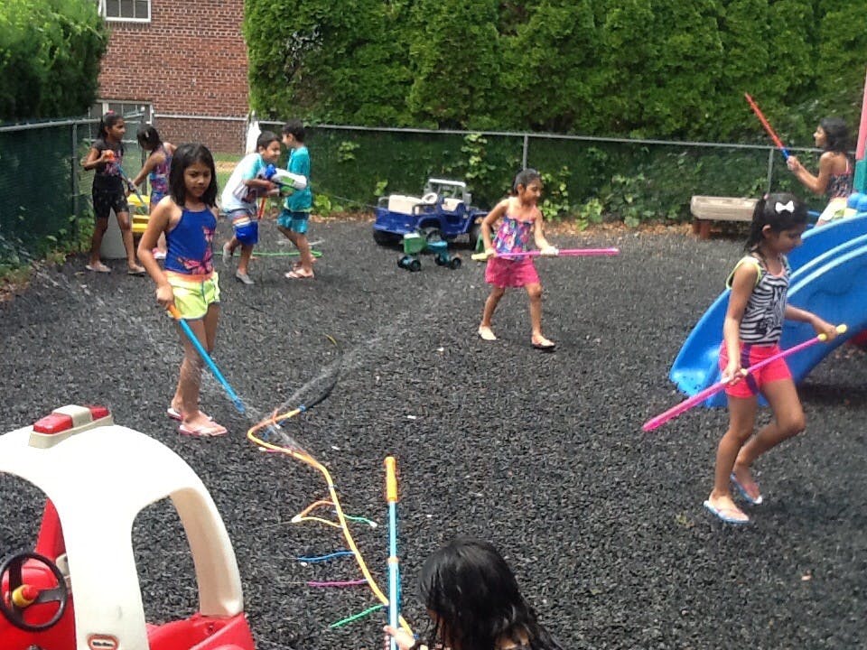 Children playing with water toys outdoors