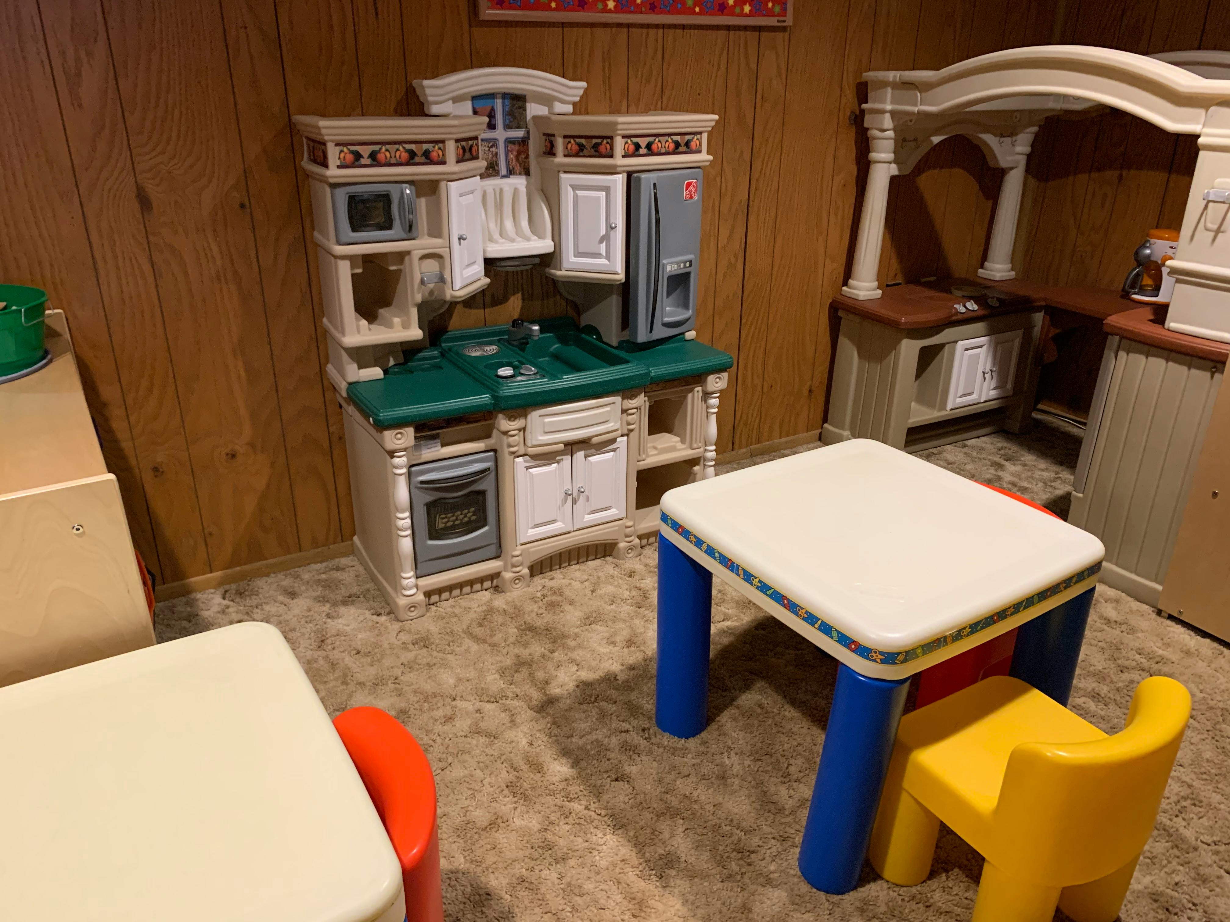 Children's play kitchen set with tables and chairs