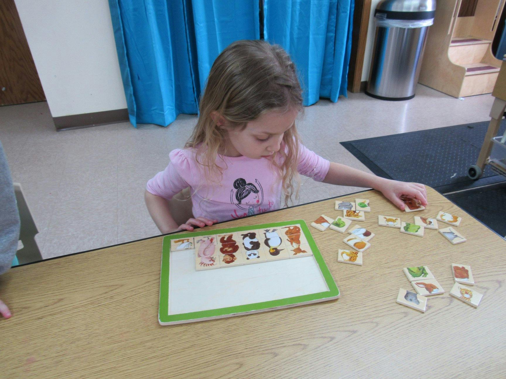 Child playing with a puzzle on a table