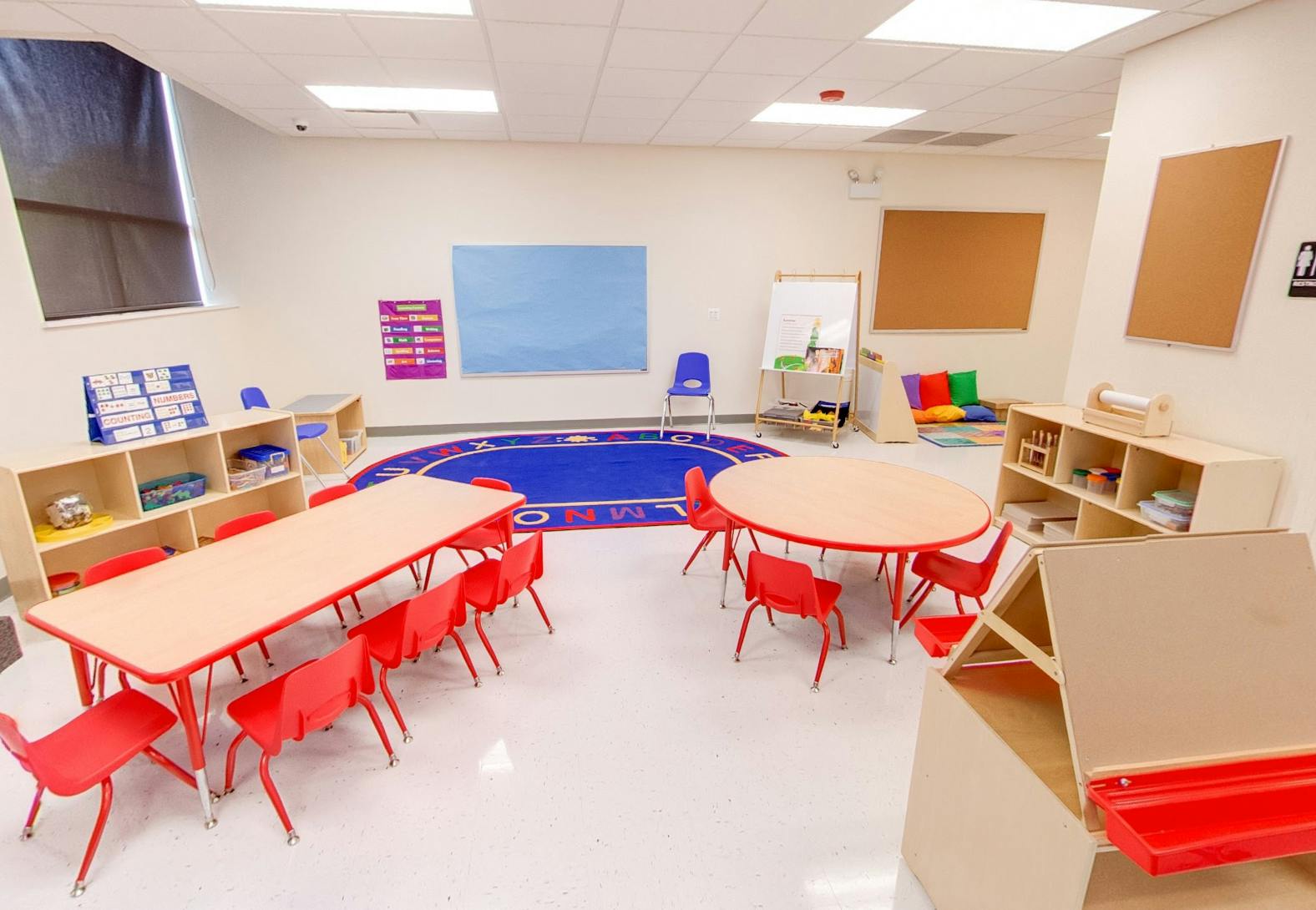 Empty classroom with small tables and chairs