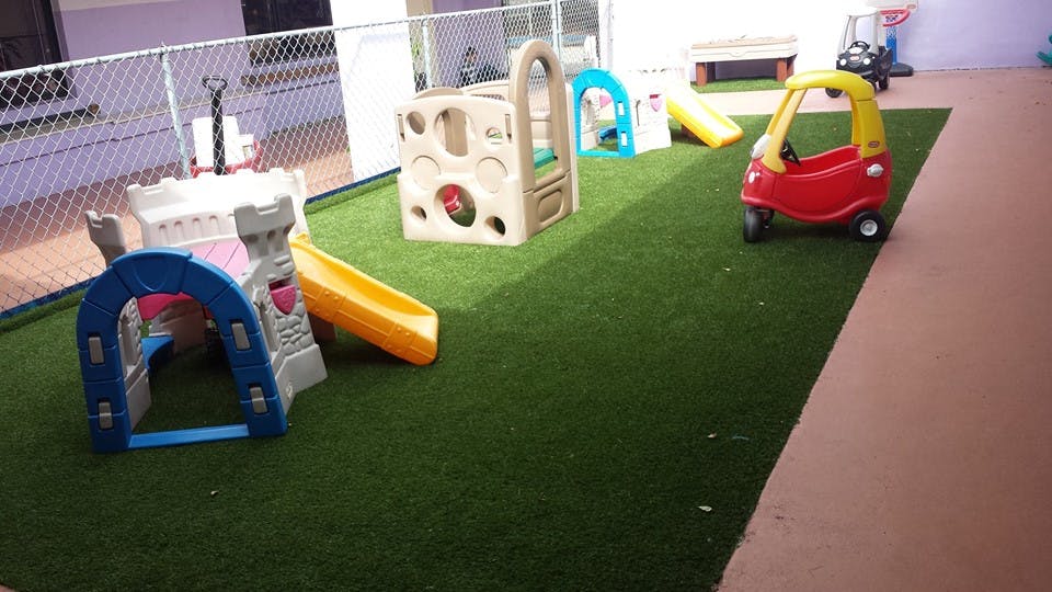 Playground with small slides and toy car on artificial turf